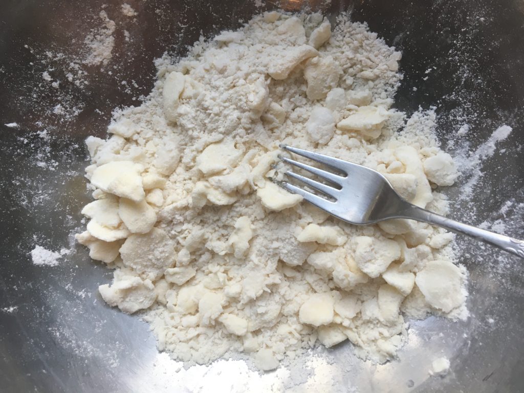 Squished butter distributed in flour for pie crust