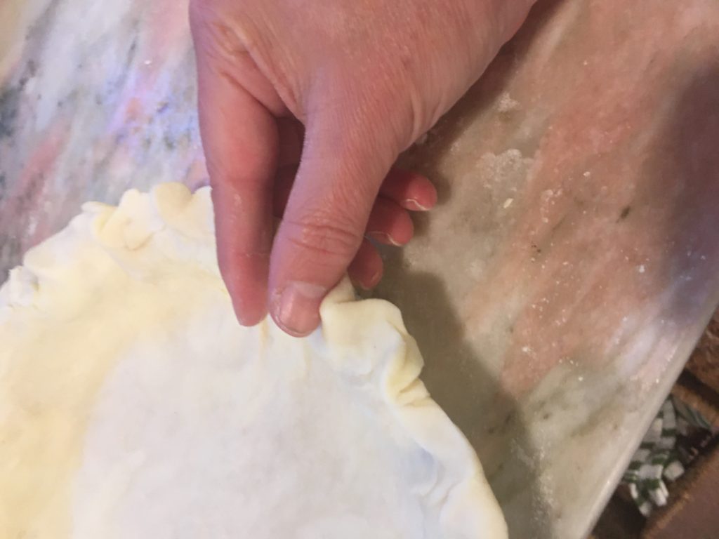Pinching the edge of the pie crust